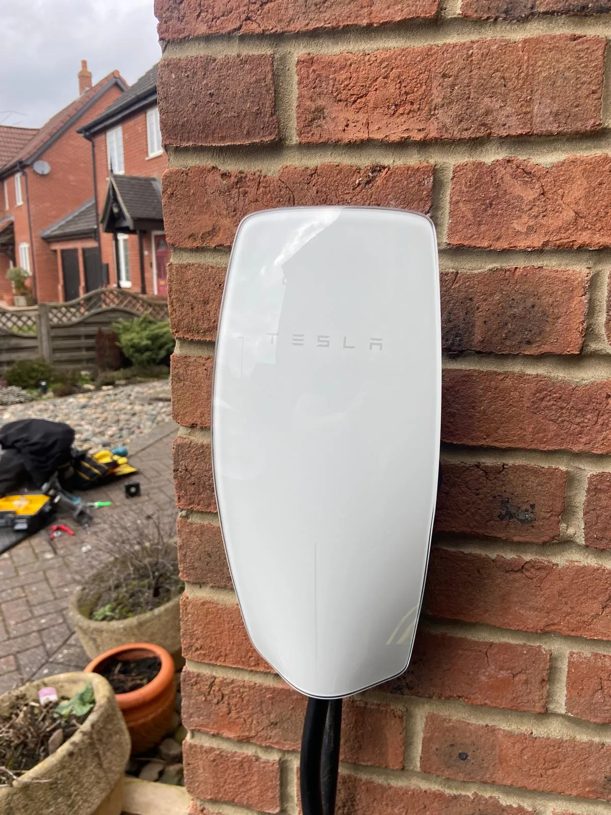 a white wall mounted device on a brick wall